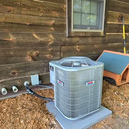 Central AC condenser install, log home